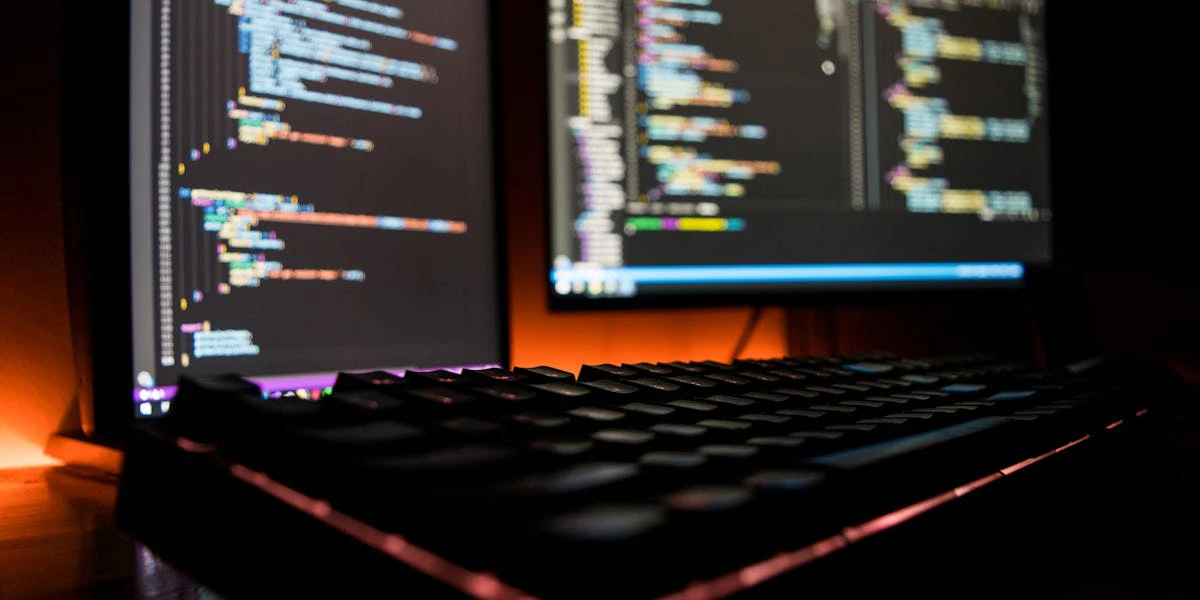 laptop and dekstop screens with code